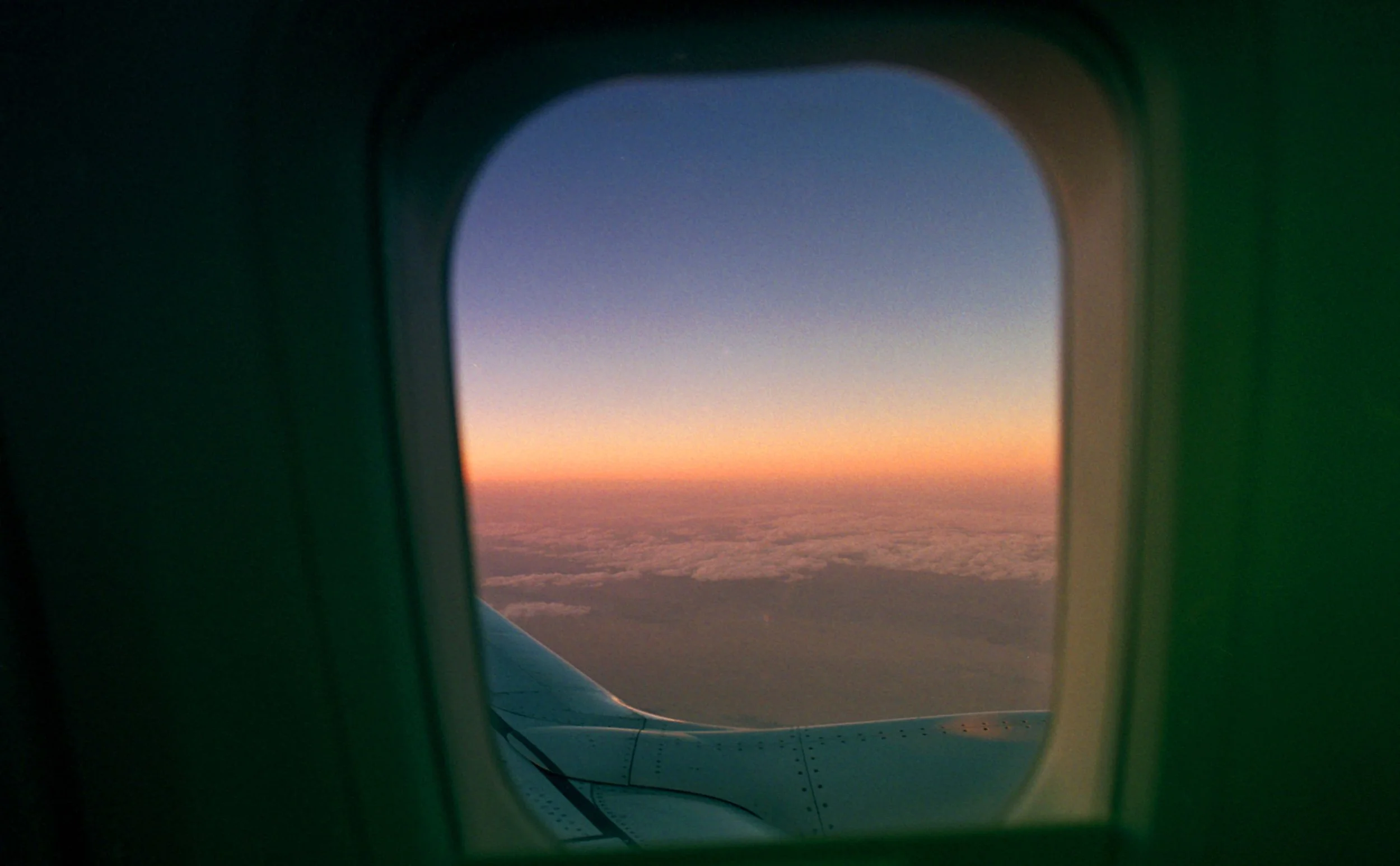 Sunset view through an airplane window. OCD counseling in Boston, MA can help you practice mindfulness without anxiety taking over. Read more about mindfulness for OCD here.