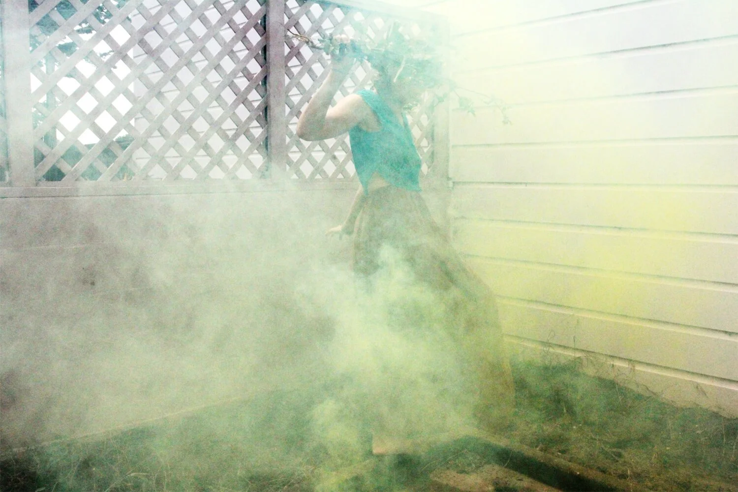 An individual walking holding flowers through smoke. OCD therapy in Boston, MA can help you with mustrust & self-doubt. To get started, reach out to an OCD therapist.
