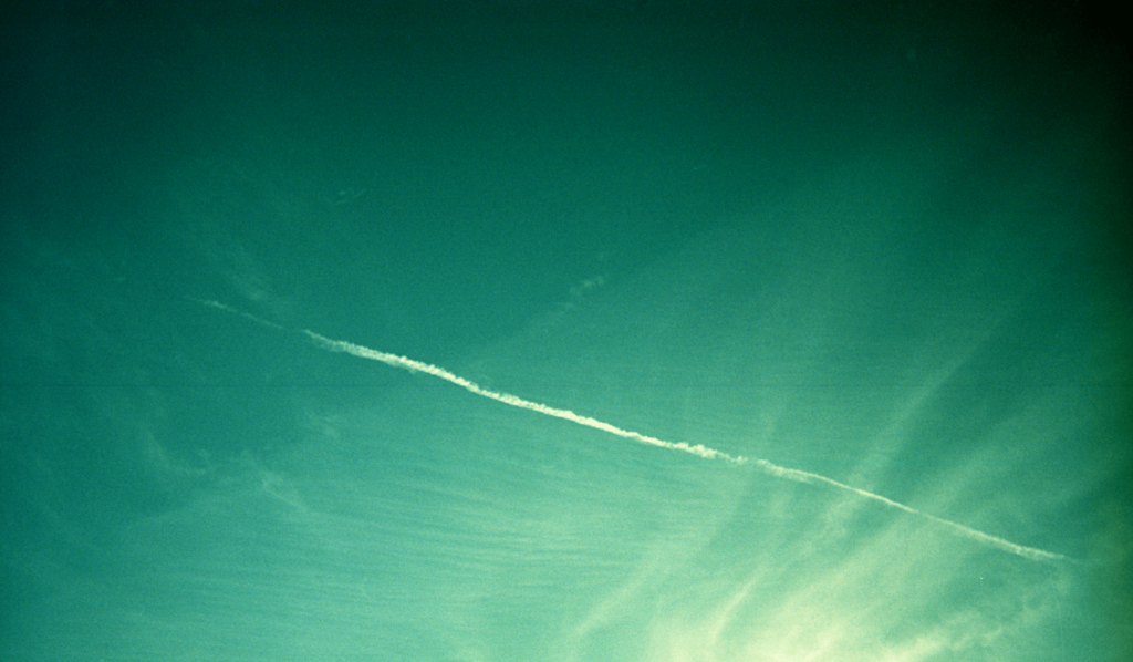 A chem trail from an airplane in a bright blue sky. OCD counseling in Boston, MA is here to support anyone who constantly questions their relationship. Learn more here.